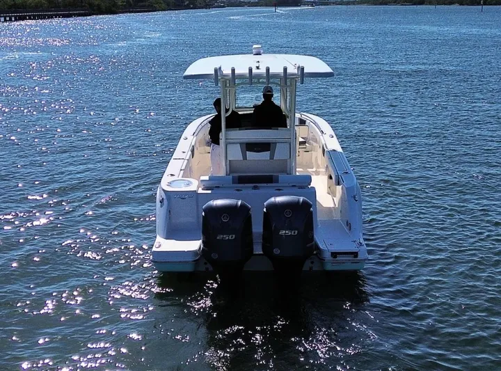  Yacht Photos Pics 2021 Robalo 272 boat cruising on a sunny day with twin engines.