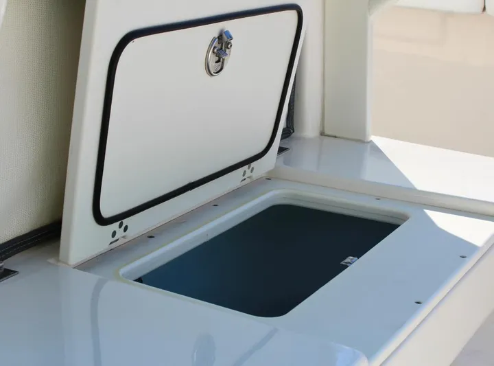  Yacht Photos Pics 2021 Robalo 272 boat storage compartment with open hatch.