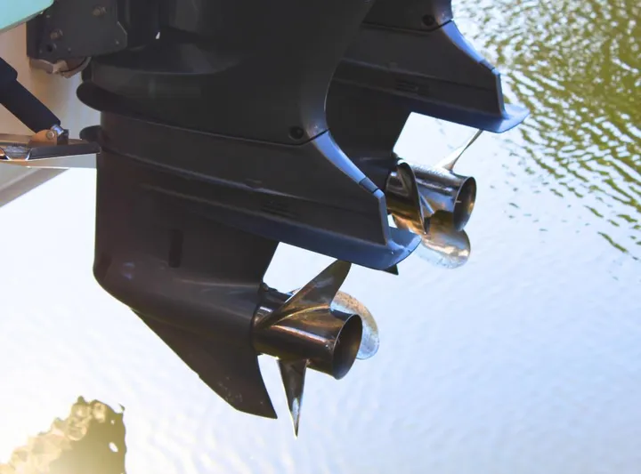  Yacht Photos Pics Twin outboard motors on a 2021 Robalo 272 boat, reflecting on water.