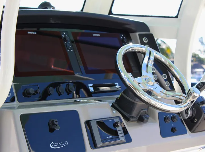  Yacht Photos Pics Robalo 272 boat dashboard with steering wheel and navigation screens, 2021 model.