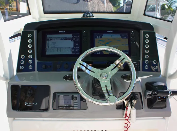 Yacht Photos Pics 2021 Robalo 272 boat dashboard with dual Simrad displays and steering wheel.
