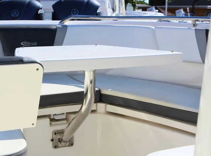  Yacht Photos Pics 2021 Robalo 272 boat interior with seating and table setup.