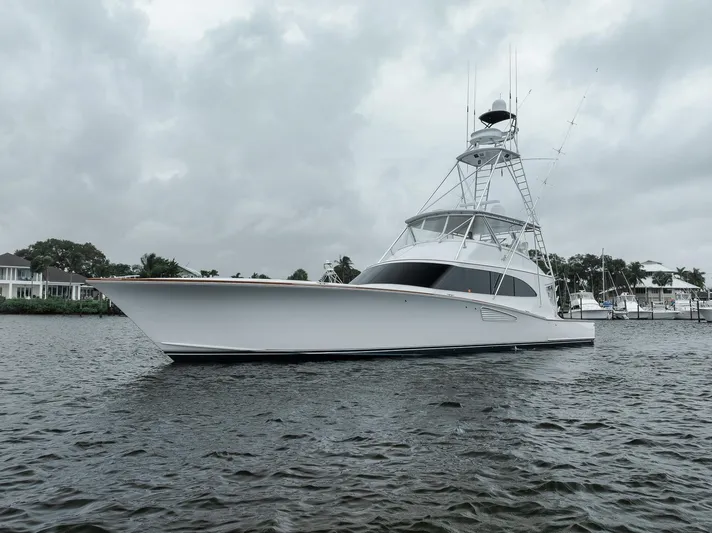  Yacht Photos Pics 2011 Jim Smith Custom Sportfish yacht on water under cloudy sky.