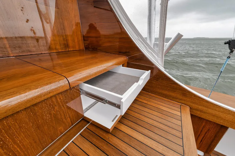  Yacht Photos Pics Wooden interior of 2011 Jim Smith Custom Sportfish boat with open drawer, overlooking the sea.