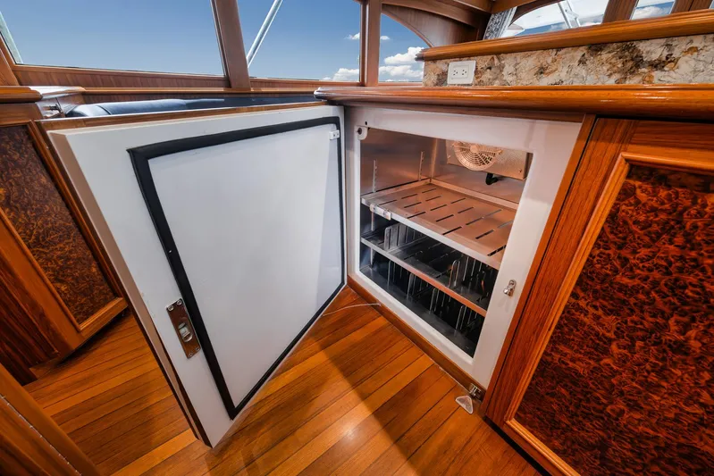  Yacht Photos Pics Open refrigerator on 2011 Jim Smith Custom Sportfish yacht with wooden interior detailing.