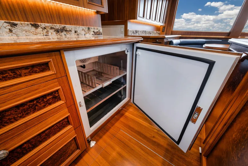  Yacht Photos Pics Luxurious wooden interior of 2011 Jim Smith Custom Sportfish with open refrigerator.