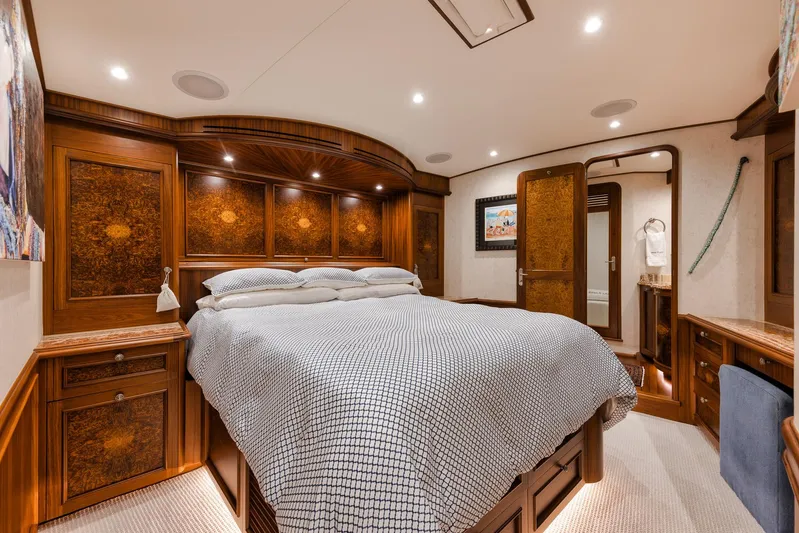  Yacht Photos Pics Luxurious bedroom interior on 2011 Jim Smith Custom Sportfish yacht, featuring elegant woodwork and cozy bedding.