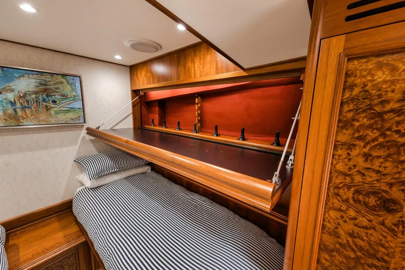  Yacht Photos Pics Luxurious cabin interior of 2011 Jim Smith Custom Sportfish with striped bedding and wood accents.