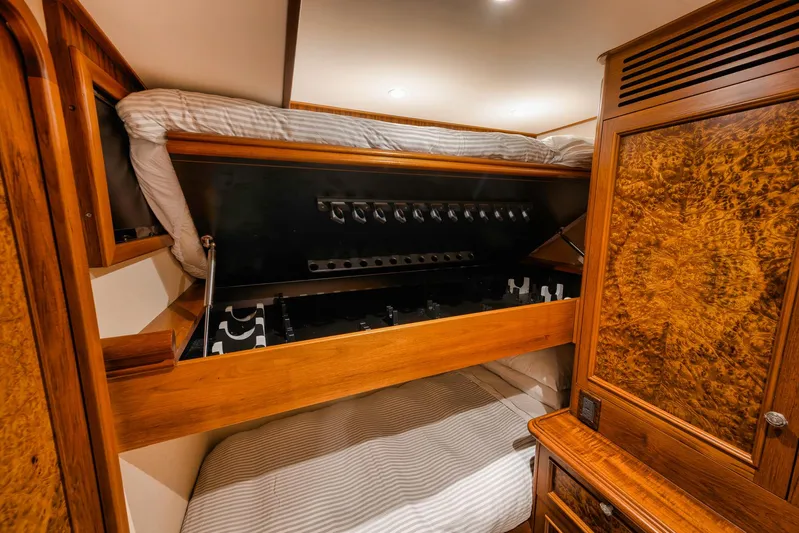  Yacht Photos Pics Luxurious cabin interior of 2011 Jim Smith Custom Sportfish with wood finishes and cozy bedding.