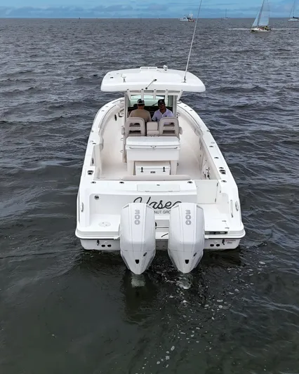  Yacht Photos Pics 2021 Boston Whaler 330 Outrage boat on open water, rear view with dual engines.