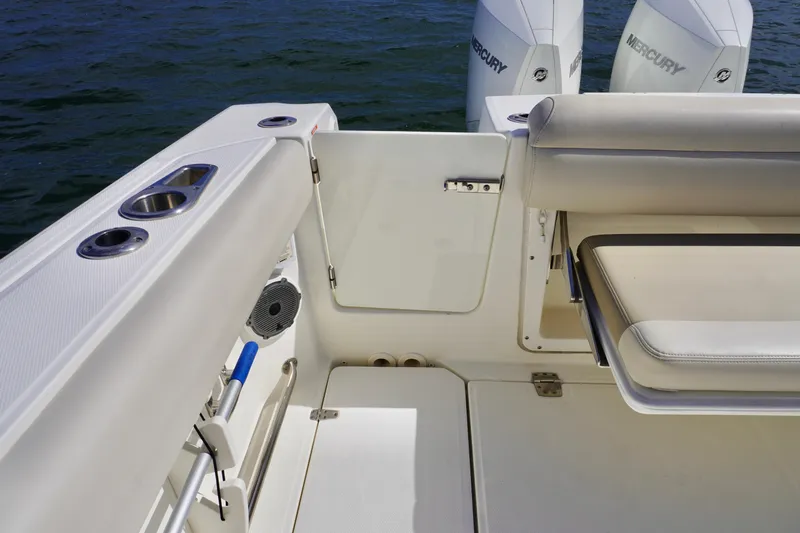  Yacht Photos Pics 2021 Boston Whaler 330 Outrage boat interior with seating and Mercury engines.