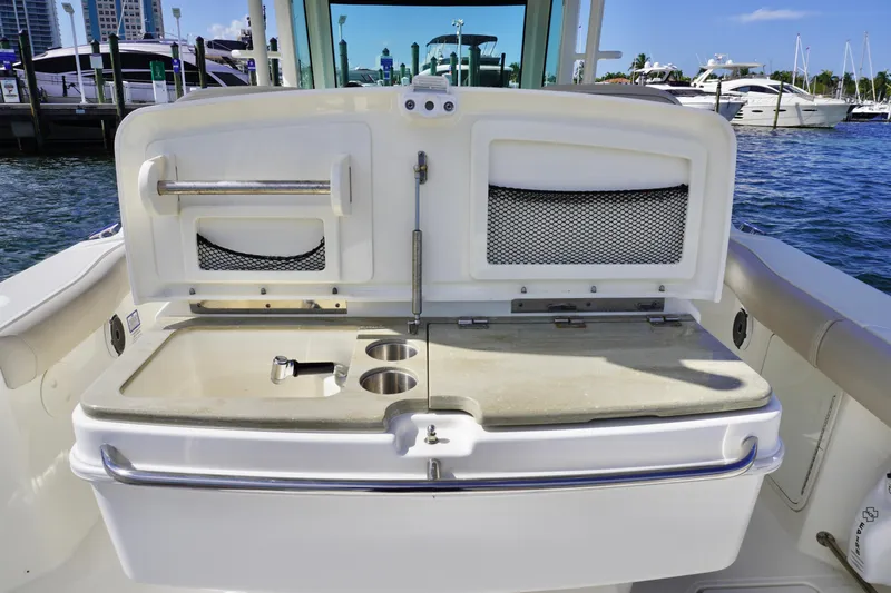  Yacht Photos Pics 2021 Boston Whaler 330 Outrage boat interior with storage compartments and cup holders.