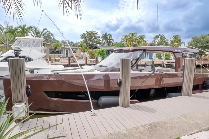  Yacht Photos Pics 2024 Fjord 41 XP yacht docked, surrounded by tropical scenery and palm trees.