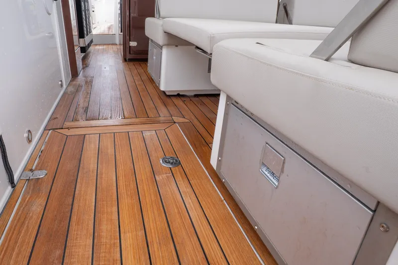  Yacht Photos Pics 2024 Fjord 41 XP yacht interior with teak flooring and cushioned seating.