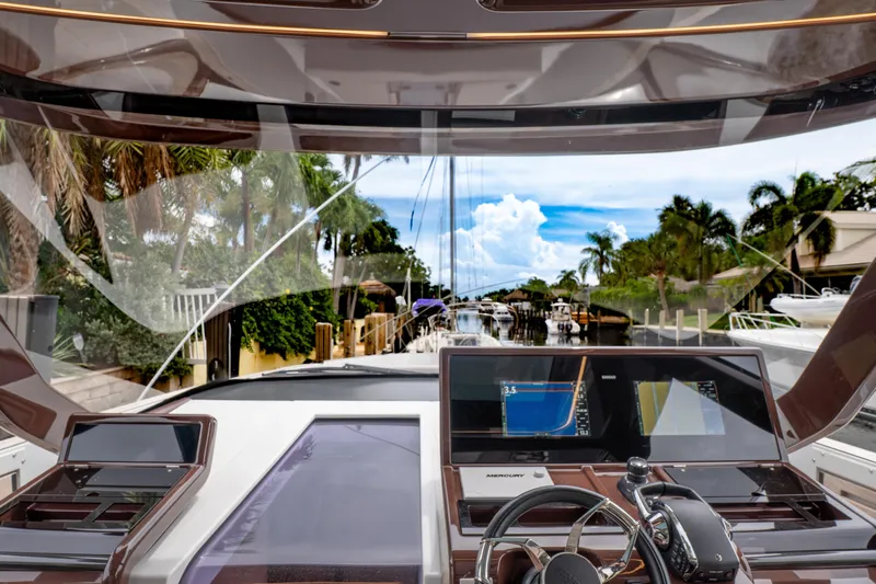  Yacht Photos Pics 2024 Fjord 41 XP yacht cockpit with advanced navigation screens and tropical canal view.
