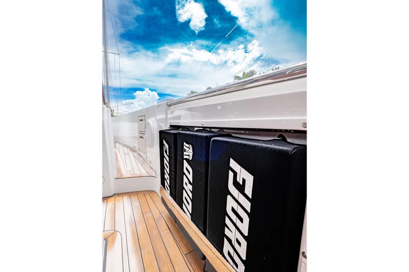  Yacht Photos Pics 2024 Fjord 41 XP yacht deck with branded cushions under a vibrant sky.