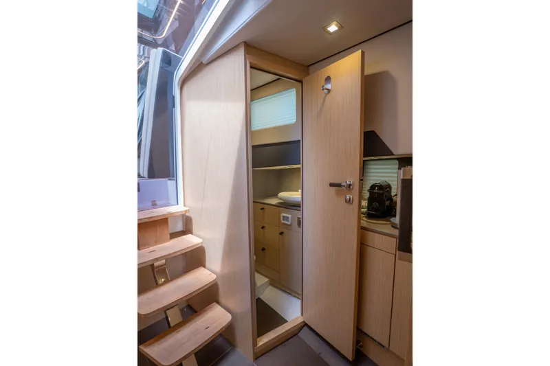  Yacht Photos Pics Interior of 2024 Fjord 41 XP yacht, featuring wooden stairs and modern cabinetry.