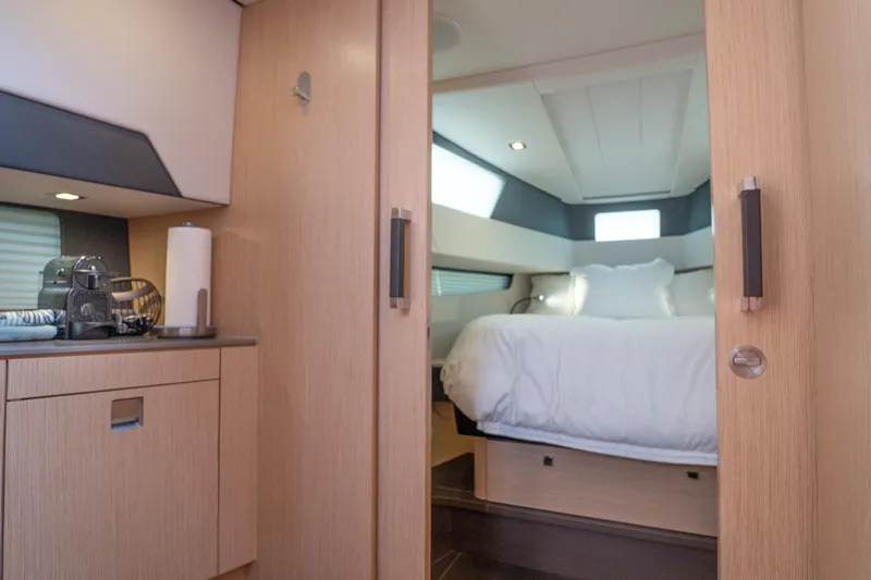  Yacht Photos Pics Luxurious interior of 2024 Fjord 41 XP yacht with cozy bedroom and modern amenities.