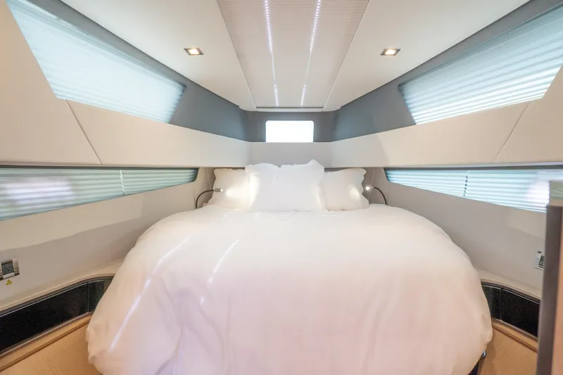  Yacht Photos Pics Luxurious bedroom interior of 2024 Fjord 41 XP yacht with modern design and cozy bedding.