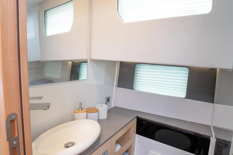  Yacht Photos Pics Modern bathroom interior of 2024 Fjord 41 XP yacht with sleek design and natural lighting.