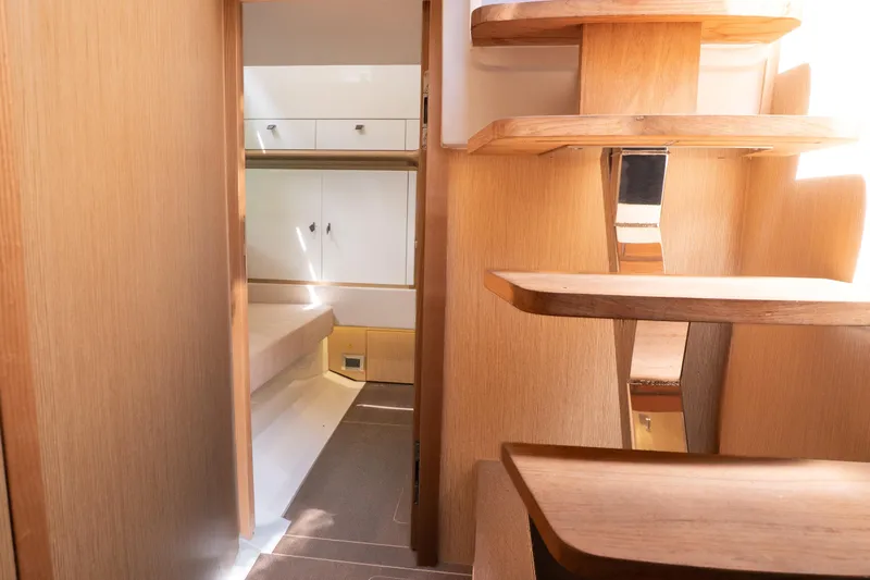  Yacht Photos Pics 2024 Fjord 41 XP yacht interior with wooden stairs and modern cabin design.
