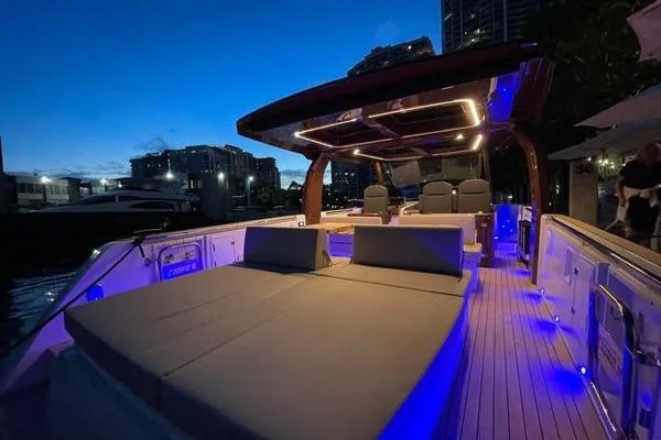  Yacht Photos Pics 2024 Fjord 41 XP yacht with illuminated deck at dusk, showcasing luxury seating and modern design.