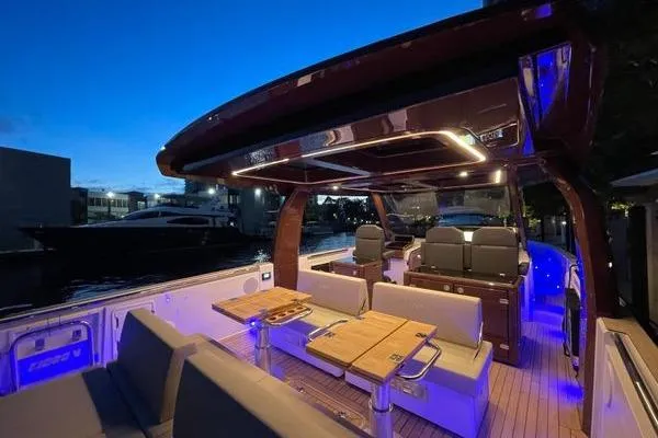  Yacht Photos Pics 2024 Fjord 41 XP yacht interior with modern seating and ambient lighting at dusk.