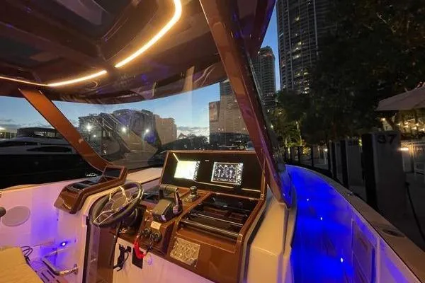  Yacht Photos Pics 2024 Fjord 41 XP yacht interior with illuminated dashboard and city skyline.