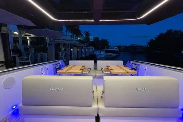  Yacht Photos Pics 2024 Fjord 41 XP yacht interior with ambient lighting and elegant seating at dusk.