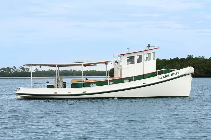Clark Mills Yacht Photos Pics 1972 Mills Boat Works Tug Boat on calm water, side view.