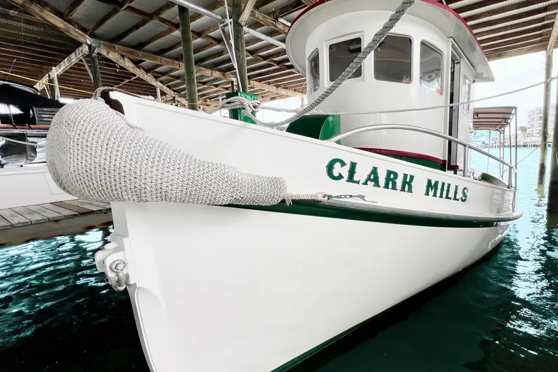 Clark Mills Yacht Photos Pics 1972 Mills Boat Works Tug Boat docked, named "Clark Mills," with white and green accents.