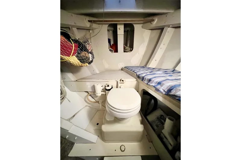 Clark Mills Yacht Photos Pics 1972 Mills Boat Works Tug Boat interior with toilet and striped bedding.