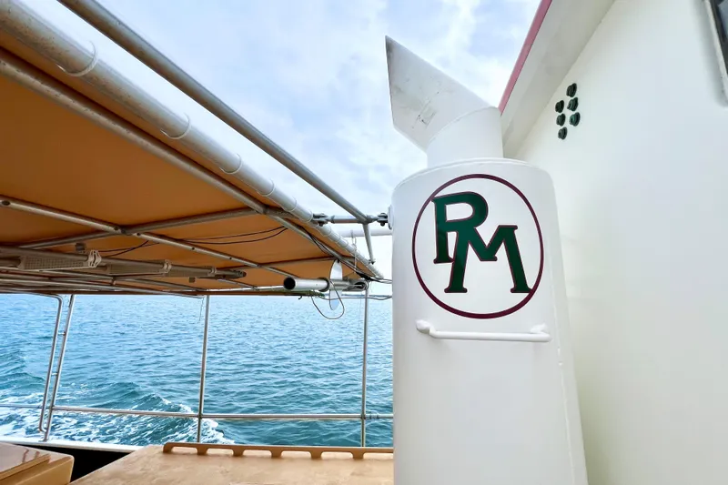 Clark Mills Yacht Photos Pics 1972 Mills Boat Works Tug Boat on water, featuring RM logo and canopy.