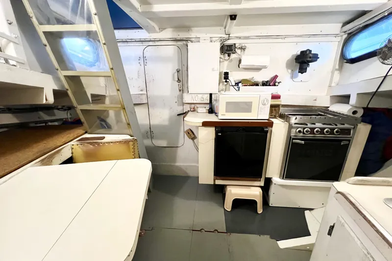 Clark Mills Yacht Photos Pics 1972 Mills Boat Works Tug Boat interior with kitchen appliances and dining area.