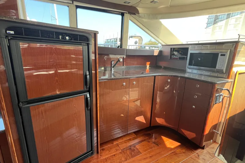  Yacht Photos Pics Luxurious kitchen interior of 2012 Meridian 441 Sedan yacht with wood cabinetry.