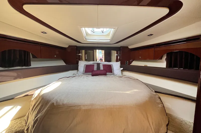  Yacht Photos Pics Luxurious bedroom interior of 2012 Meridian 441 Sedan yacht with skylight and elegant wood finish.