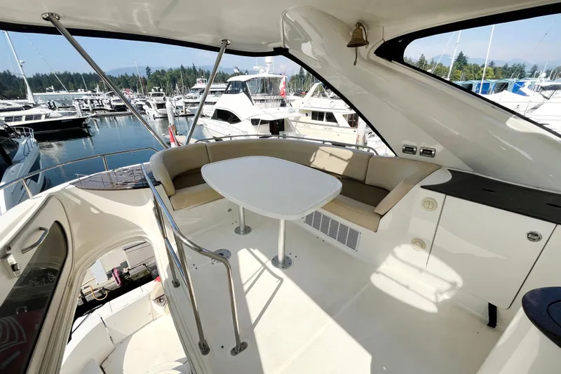  Yacht Photos Pics 2012 Meridian 441 Sedan yacht interior with seating and table at marina.