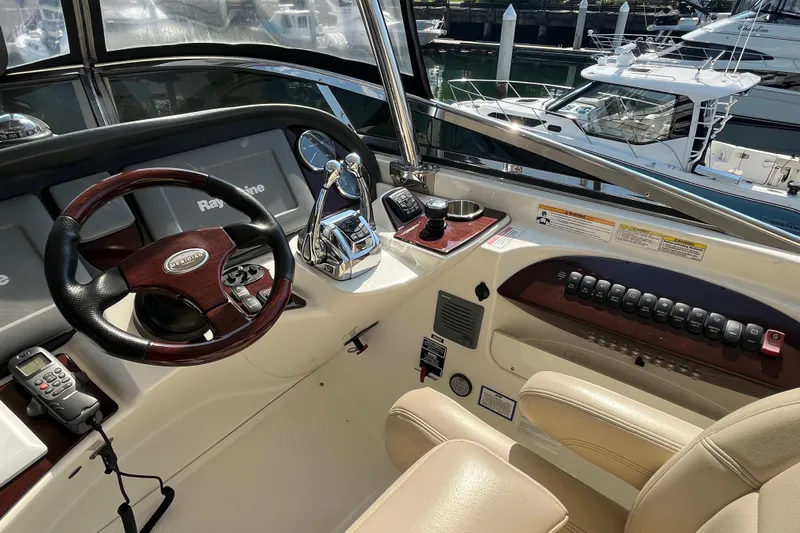 Yacht Photos Pics Cockpit of 2012 Meridian 441 Sedan yacht with steering wheel and control panel.