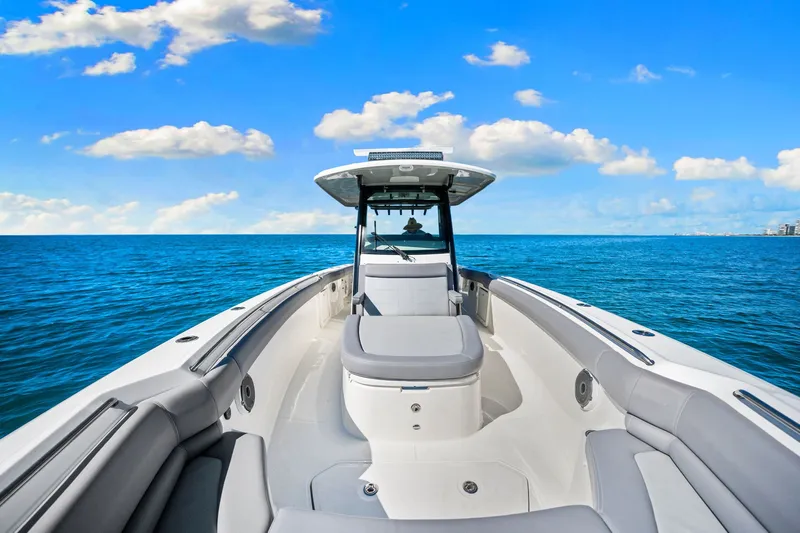  Yacht Photos Pics 2022 Boston Whaler 330 Outrage boat on open sea under blue sky.