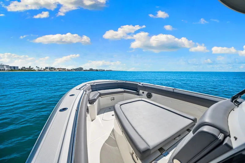  Yacht Photos Pics 2022 Boston Whaler 330 Outrage boat on open sea under blue sky.