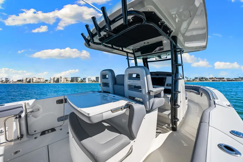  Yacht Photos Pics 2022 Boston Whaler 330 Outrage boat interior with ocean and city skyline view.