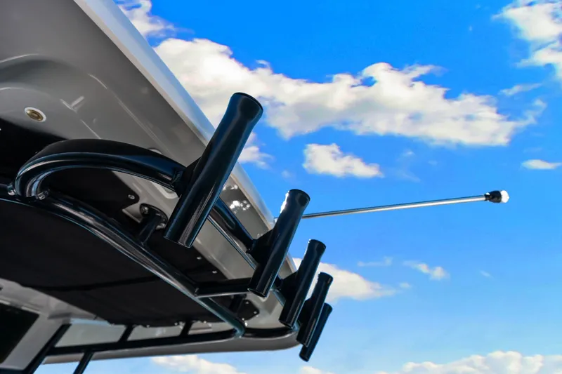  Yacht Photos Pics Boston Whaler 330 Outrage 2022 boat rod holders against a bright blue sky.