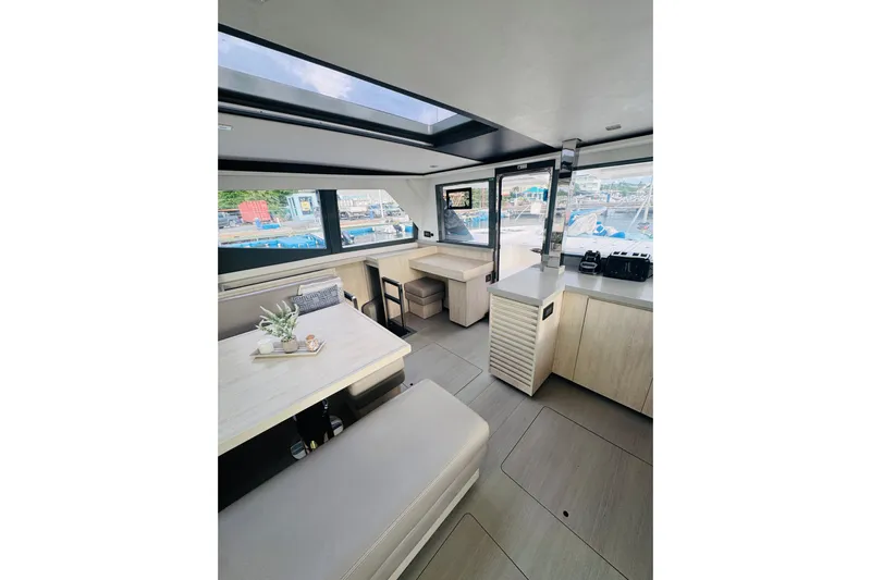 Stargazer Yacht Photos Pics Interior of 2017 Robertson and Caine Leopard yacht, featuring modern dining and seating area.