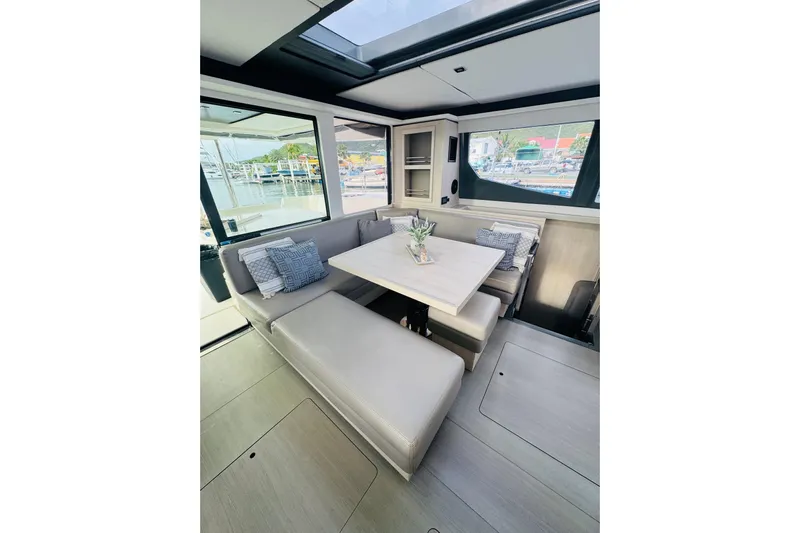 Stargazer Yacht Photos Pics 2017 Robertson and Caine Leopard yacht interior with elegant dining area and scenic marina view.