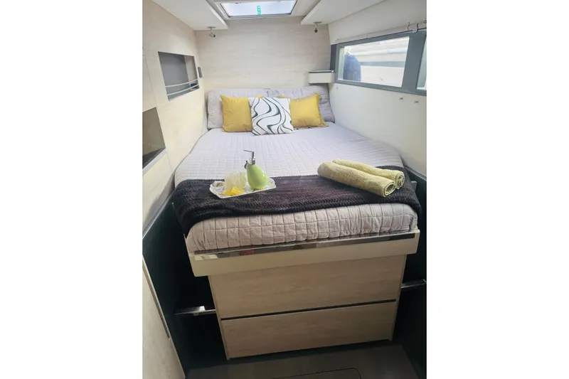 Stargazer Yacht Photos Pics Cozy bedroom interior of 2017 Robertson and Caine Leopard yacht with bed and skylight.