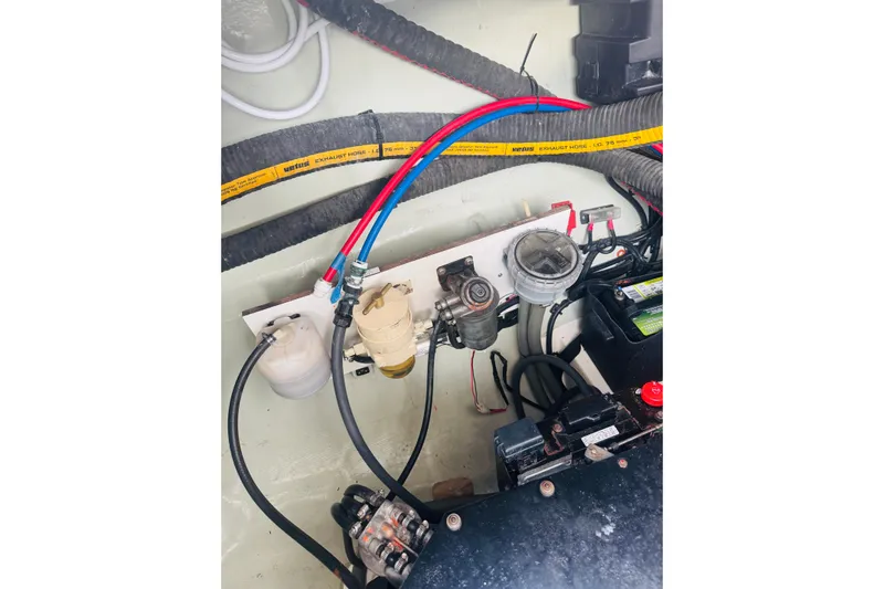 Stargazer Yacht Photos Pics Engine compartment of a 2017 Robertson and Caine Leopard boat, showing hoses and components.