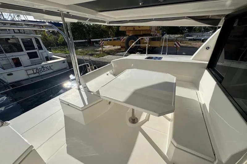 Stargazer Yacht Photos Pics 2017 Robertson and Caine Leopard yacht deck with seating and table in marina.