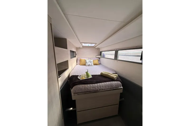 Stargazer Yacht Photos Pics Cozy cabin interior of 2017 Robertson and Caine Leopard yacht with bed and windows.