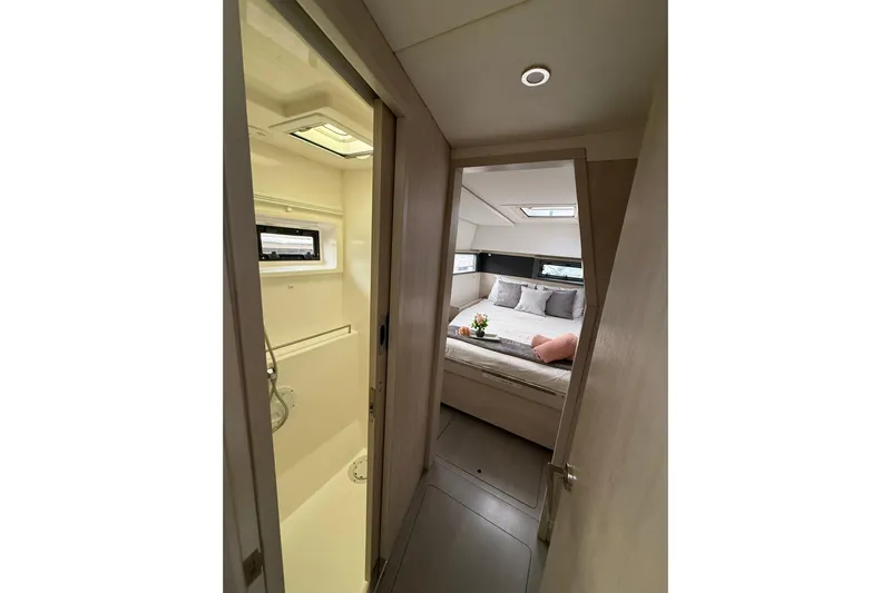 Stargazer Yacht Photos Pics Interior of 2017 Robertson and Caine Leopard yacht, featuring a cozy bedroom and bathroom.