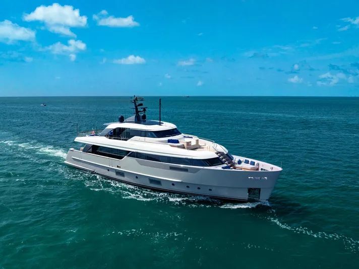 Legacy Yacht Photos Pics Luxurious 2022 Sanlorenzo SD96 yacht cruising on open sea under clear blue sky.